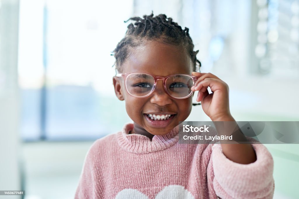 Young girl, glasses and vision with frame and lens, eyewear shopping with eye care and optometry with kid in portrait. Eye health, prescription for eyes with child at optometrist office or store.